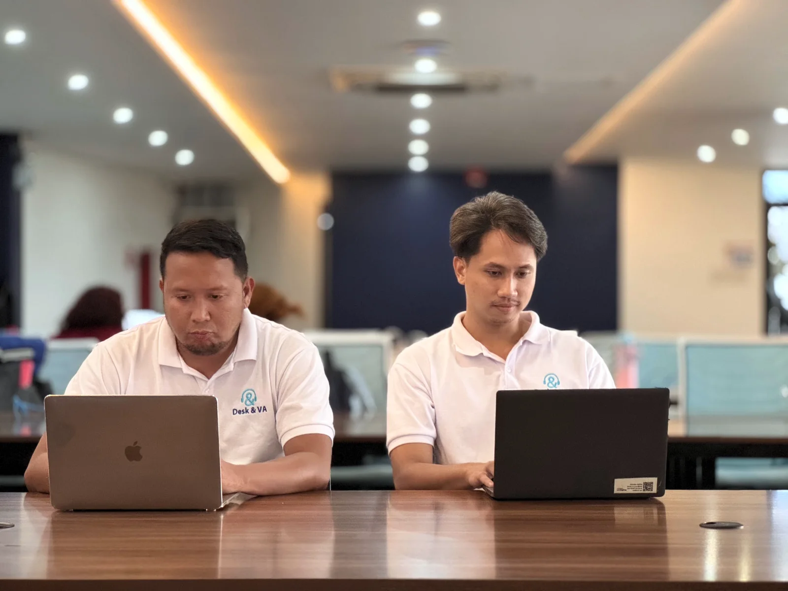 Two Desk & VA assistants working on laptops in the Downtown office