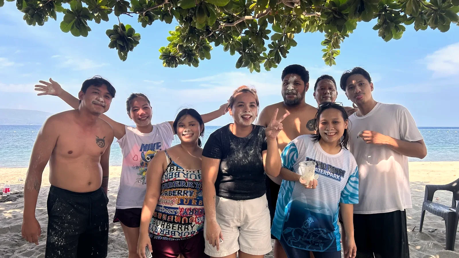 Desk & VA team members at the beach on a team-building day