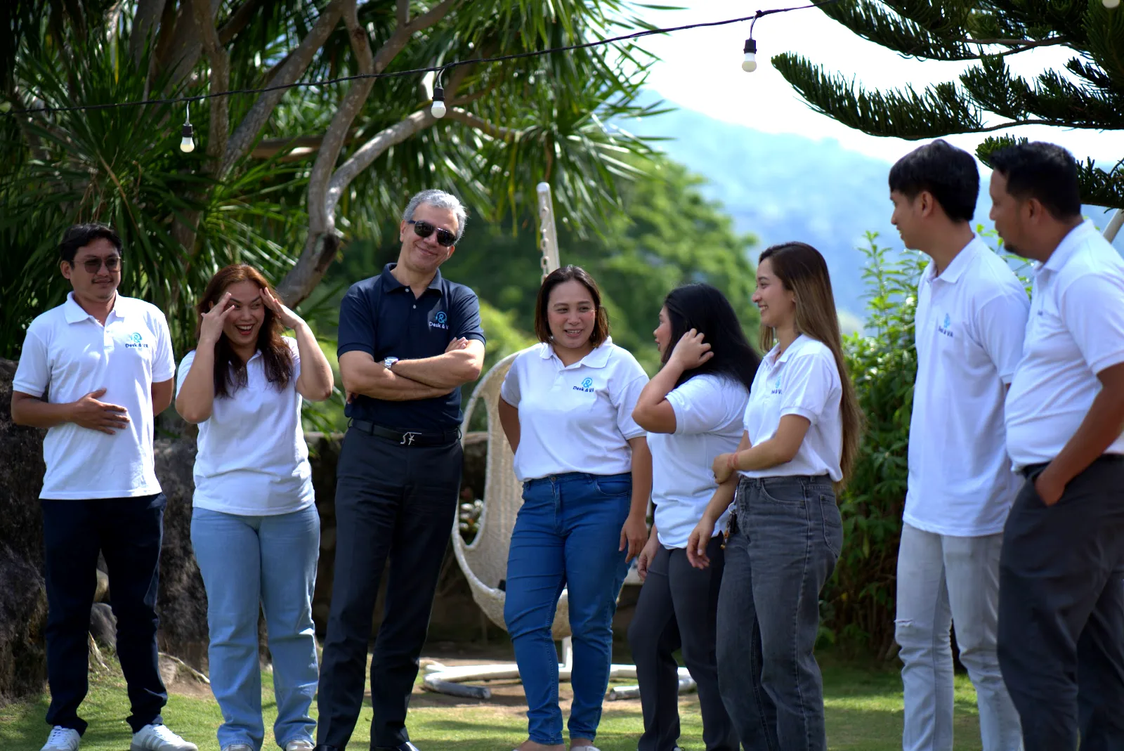 Desk & VA team members sharing a laugh on a company day out in the hills